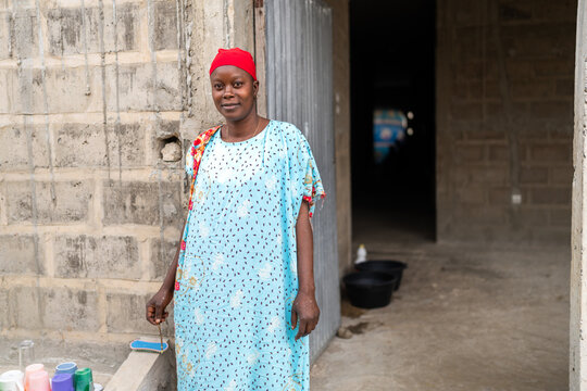 Senegalese woman standing in front of her house in Senegal, Africa