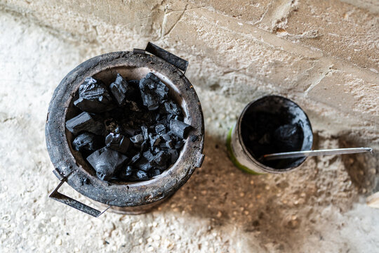 Charcoal burning in traditional brazier in Senegal, Africa