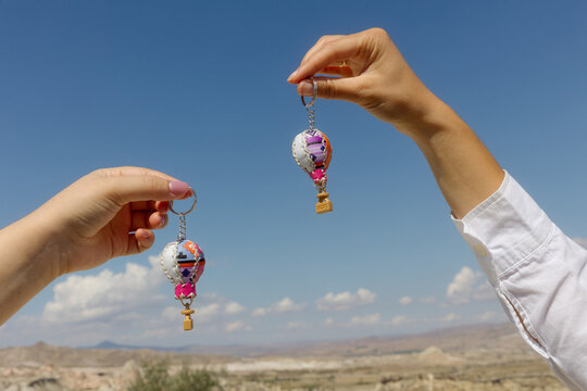 Hot air balloon keychains against blue sky