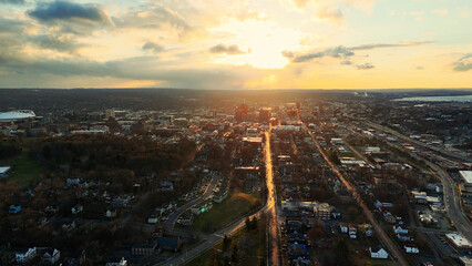 Fototapeta premium Aerial View of the Syracuse City Skyline and the network of it's roads as the sun begins to set over it.
