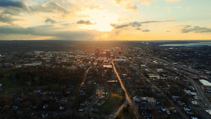 Aerial View of the Syracuse City Skyline and the network of it's roads as the sun begins to set over it.