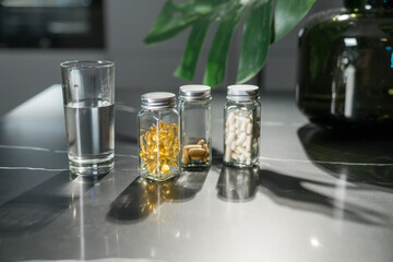 Glass Jars of Supplements with a Glass of Water 
