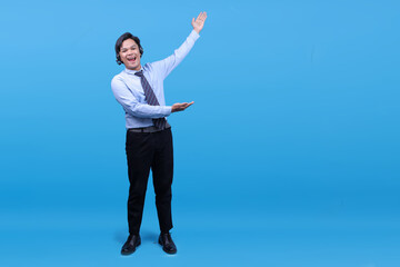 Call center agent male using headset with a big smile on face, presenting with hand to the side
