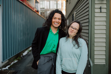 Smiling Friends Sharing a Moment in an Urban Alleyway Setting
