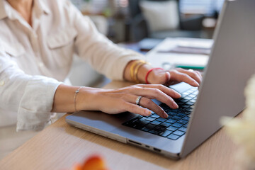 Closeup shot of businesswoman working on laptop at desk