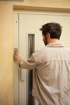 Crop of anonymous pressing elevator button