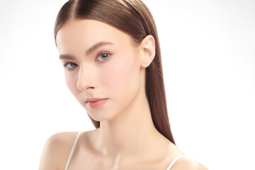 Fototapeta premium A beautiful young woman with clean, fresh skin against a white background. Skincare, facial treatment, cosmetology, beauty, and spa. An elegant portrait of an woman.
