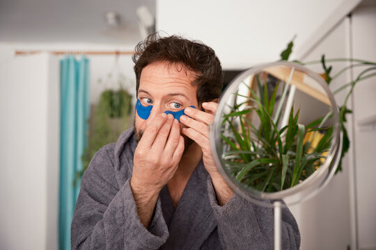 Man applying eye patches 