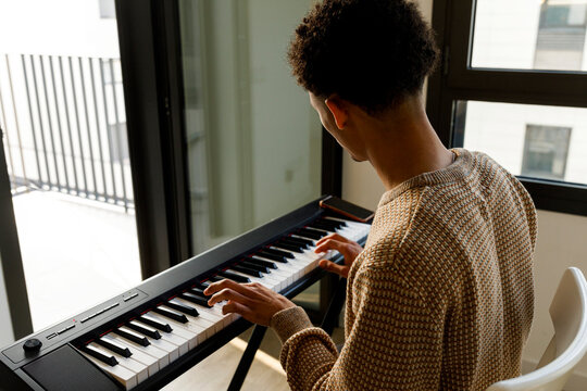 young man  plays an electric piano