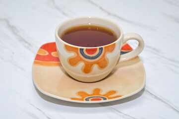 close up of tea drink in cup on marble table