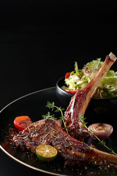 Closeup of grilled lamb chops on a plate