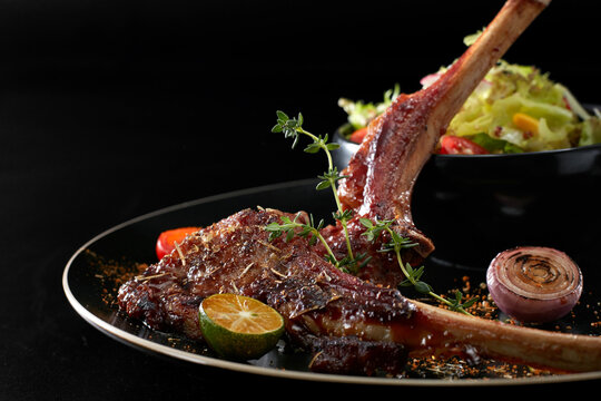 Closeup of grilled lamb chops on a plate