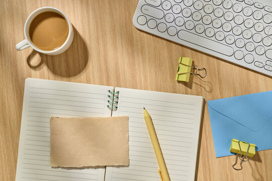 Top View of Office Desk with Notes, Coffee, and Keyboard