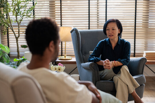 Female psychotherapist is discussing with young man