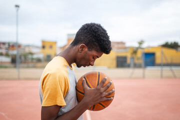 black teenager playing basketball