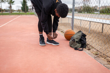 black teenager playing basketball