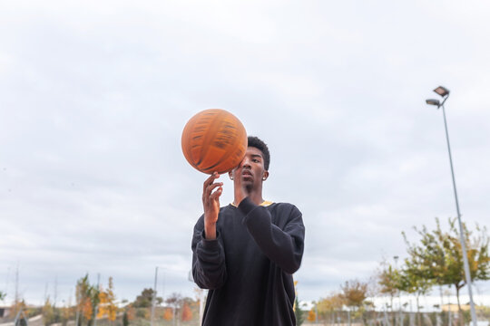 black teenager playing basketball