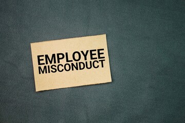 Box paper with the word employee misconduct. deliberate violation of a written or implied employee...