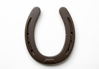 A single brown horseshoe with visible nail holes isolated on a plain white background in a studio shot