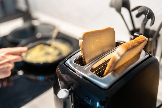 Slices of bread toasting in a toaster in a kitchen