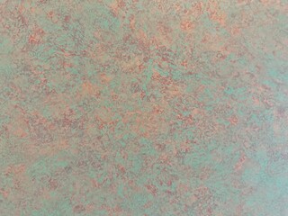 Wall painted in light green with stains in orange and brown tone for background and decorations