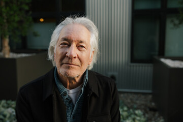 Mature Man with Grey Hair Posing Outdoors in Casual Attire