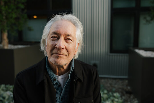 Mature Man with Grey Hair Posing Outdoors in Casual Attire