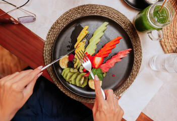 Vibrant Tropical Fruit Plate in Eclectic Dining Scene