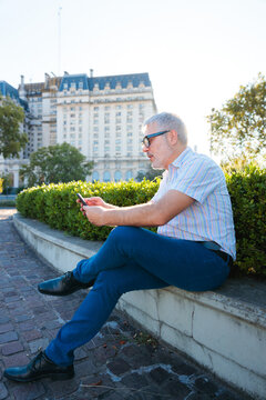 Businessman using smartphone in Buenos Aires city park