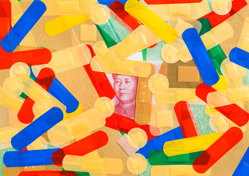 Chinese yuan banknote covered with colorful first aid strips