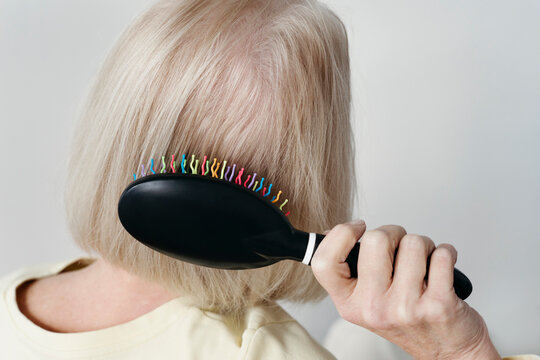 Faceless Woman Brushing Her Hair With Care