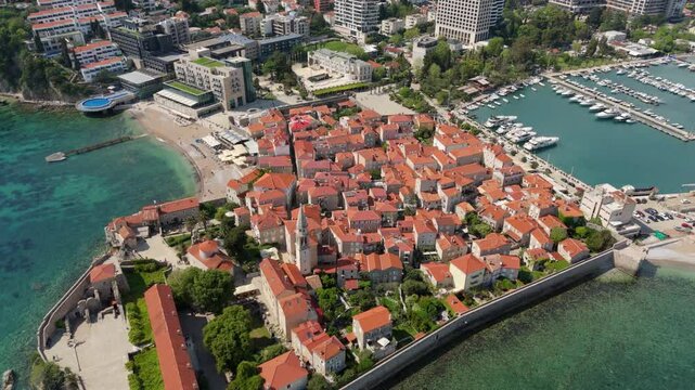 Aerial droen view Budva old town Stari harbour yachts Medieval Dubrovnik blue waters riviera mountains vacation holiday coastal Adriatic Mediterranean 