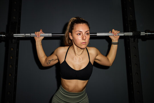 Strong woman lifting weights in a gym setting