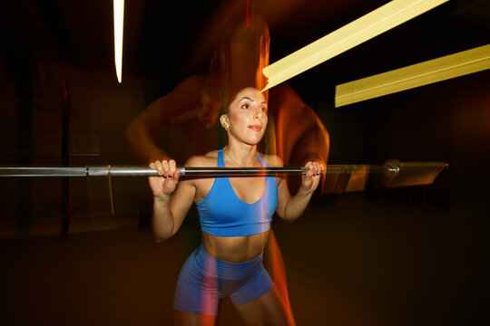 Weightlifting activity in a gym with dynamic lighting effects