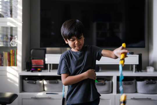 Young Boy Engaged in Play at Home in a Modern Living Room Setting