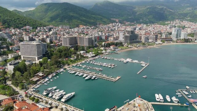 Aerial droen view Budva old town Stari harbour yachts Medieval Dubrovnik blue waters riviera mountains vacation holiday coastal Adriatic Mediterranean 