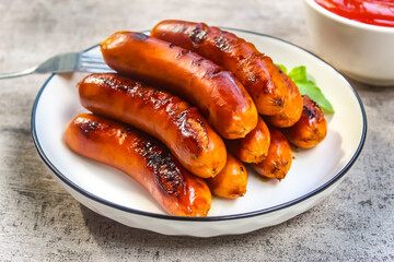 grilled sausages on a plate with tomato sauce as the main menu