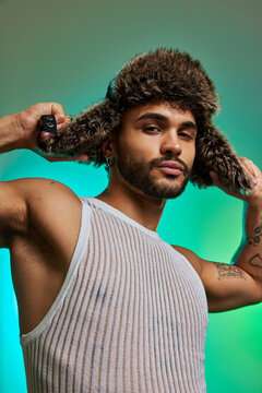 Cool man pulling fur cap