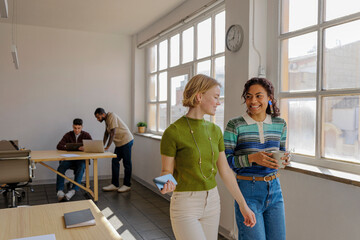 Coworkers walking and talking during office break time