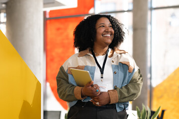 Confident Business Professional Holding Tablet in Office Setting