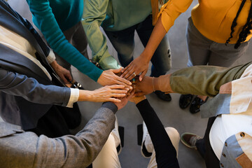 Diverse team uniting hands in a collaborative gesture