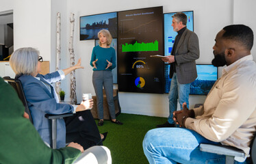 Business professionals in a meeting with data presentations