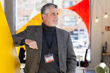 Businessman in modern office environment with name badge