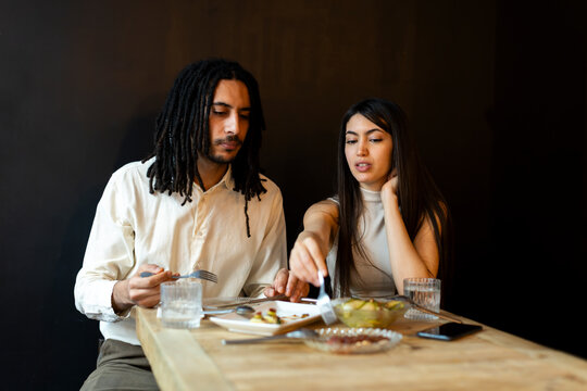 Couple eating tapas at restaurant