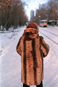 winter portrait of woman on the tram station