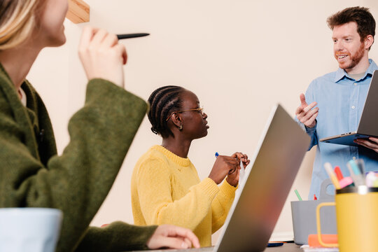 Sales executive giving a formal presentation during a business meeting