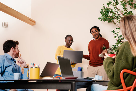 Office workers presenting a progress report to a group of executives