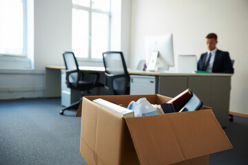 Fototapeta premium Empty Office Desk A Businessman's Departure and Cardboard Box of Belongings