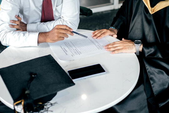 A company manager offers a work contract to a university graduate.