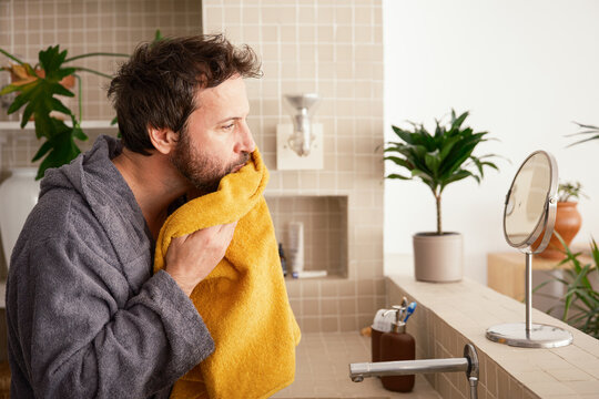 Man drying his face with a towel